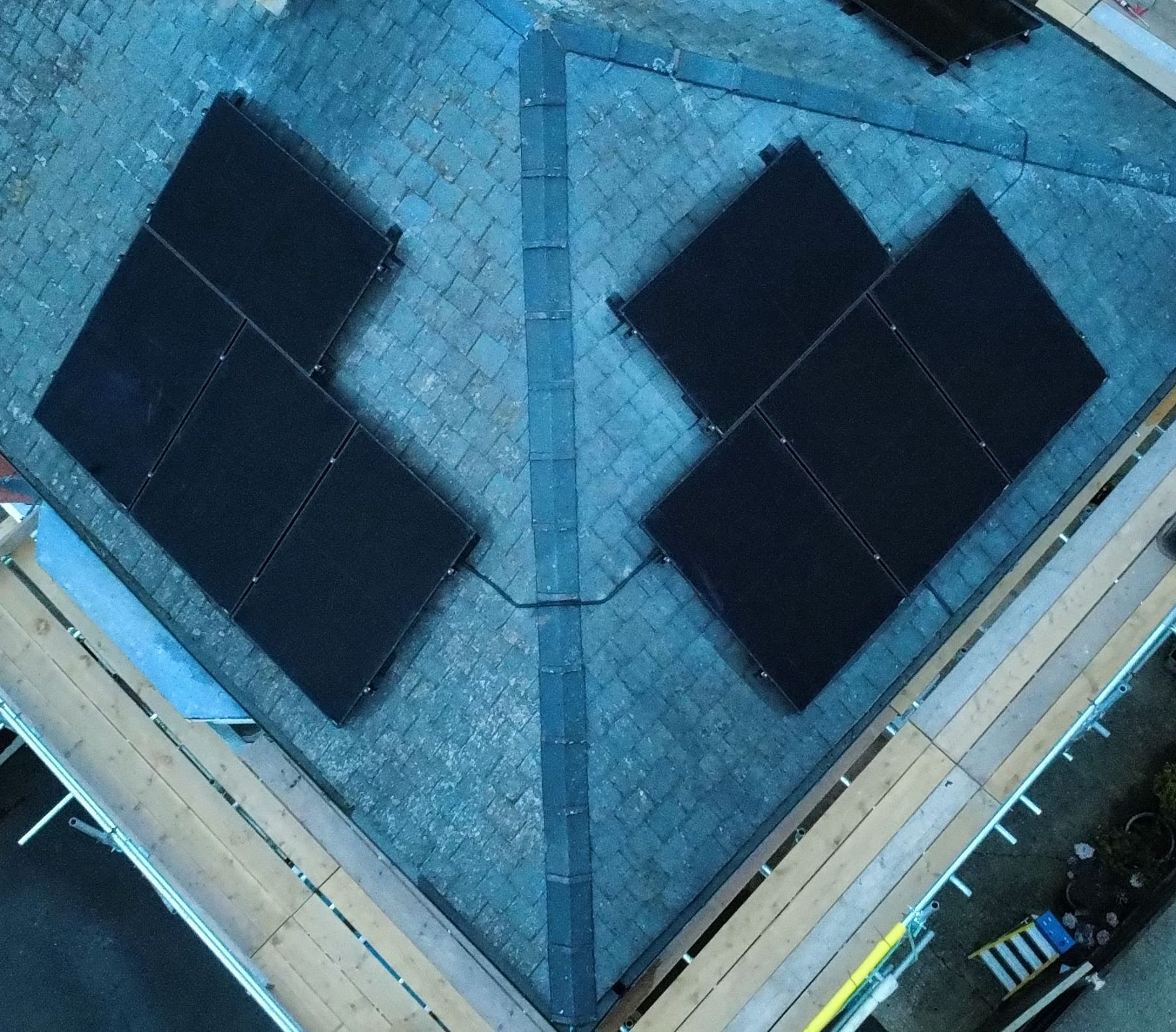 Two small arrays either side of the hip of a slate roof, seen from directly above